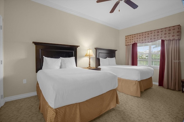 carpeted bedroom with ceiling fan and crown molding