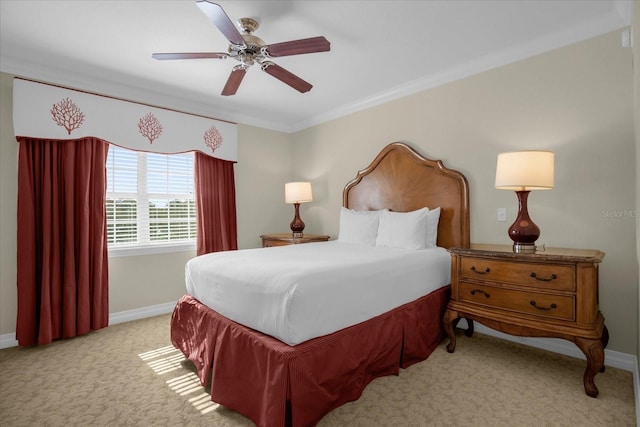 carpeted bedroom with ceiling fan and crown molding