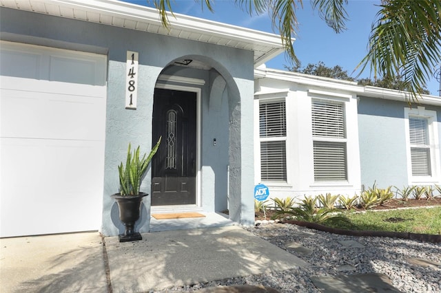 view of exterior entry with a garage