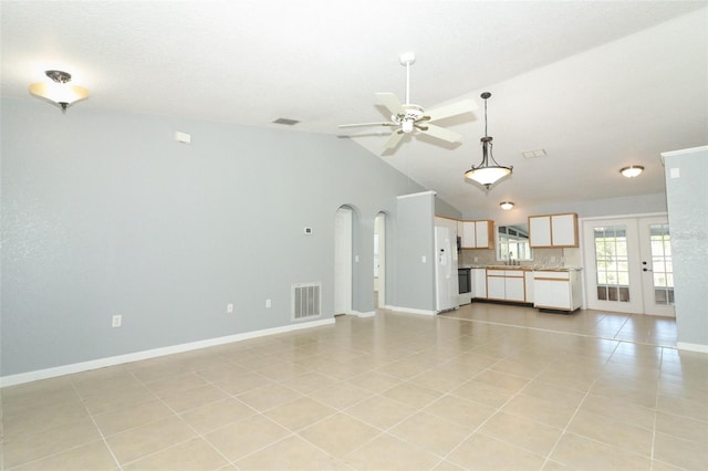 unfurnished living room featuring french doors, ceiling fan, light tile patterned floors, and lofted ceiling