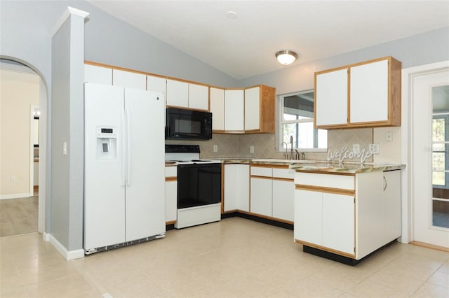 kitchen featuring white cabinets, tasteful backsplash, white appliances, and vaulted ceiling