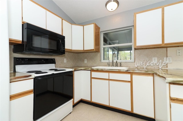 kitchen with white cabinets, decorative backsplash, sink, and electric range