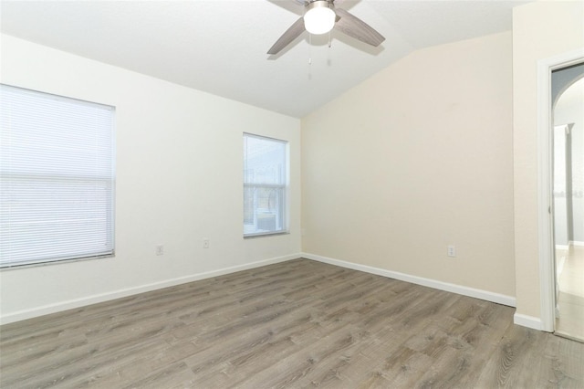 unfurnished room with hardwood / wood-style floors, lofted ceiling, and ceiling fan