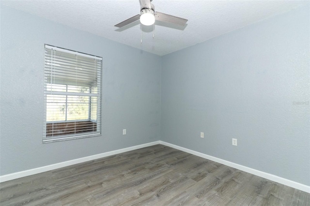 unfurnished room with ceiling fan, a textured ceiling, and dark hardwood / wood-style flooring