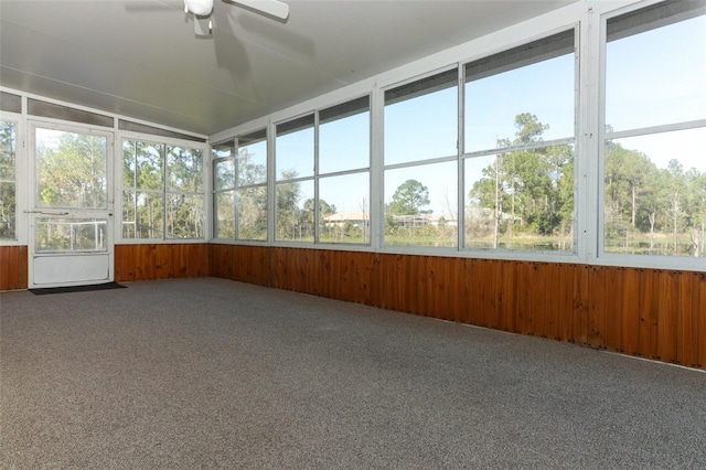 unfurnished sunroom with a wealth of natural light, vaulted ceiling, and ceiling fan