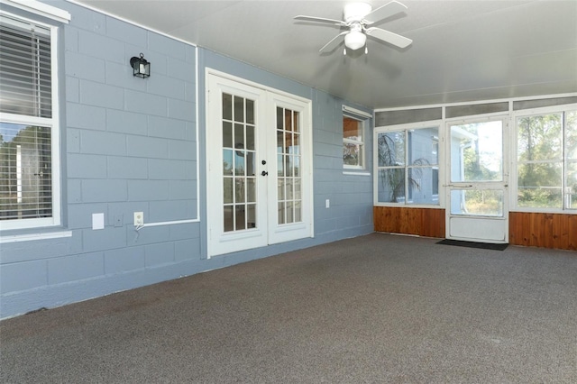 unfurnished sunroom featuring french doors and ceiling fan