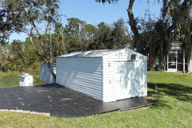 view of outbuilding featuring a lawn