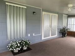 unfurnished sunroom featuring ceiling fan