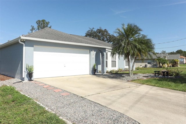 single story home with a garage and a front yard