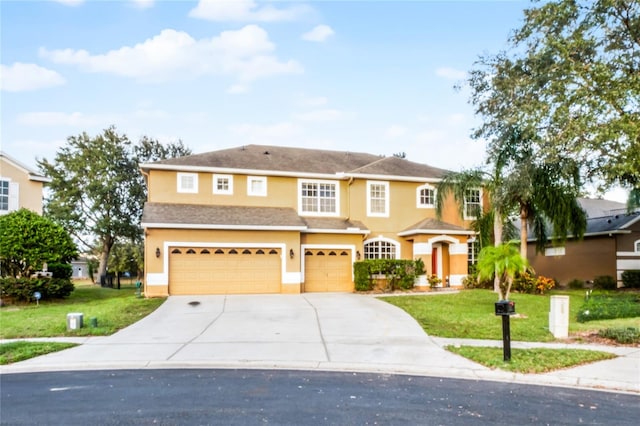 view of front of property featuring a garage and a front yard