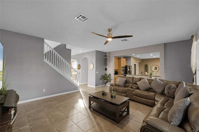 living room with ceiling fan and light tile patterned floors