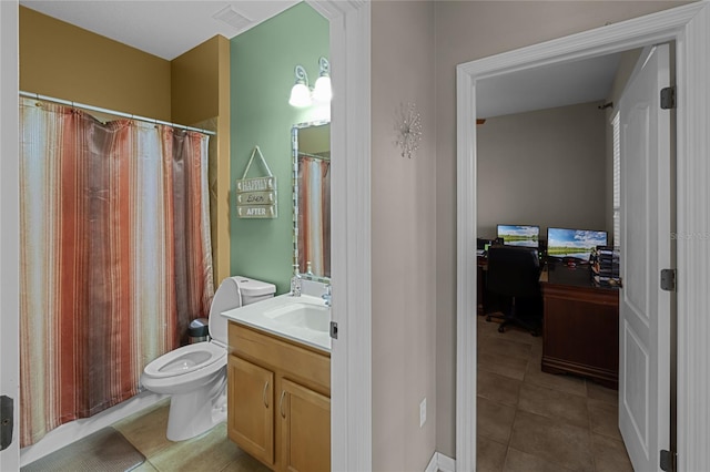 bathroom with tile patterned flooring, vanity, and toilet