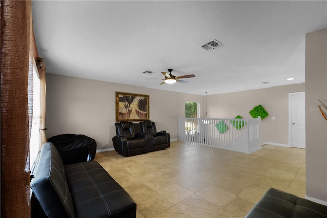 tiled living room featuring ceiling fan