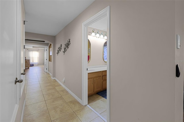 corridor with light tile patterned flooring