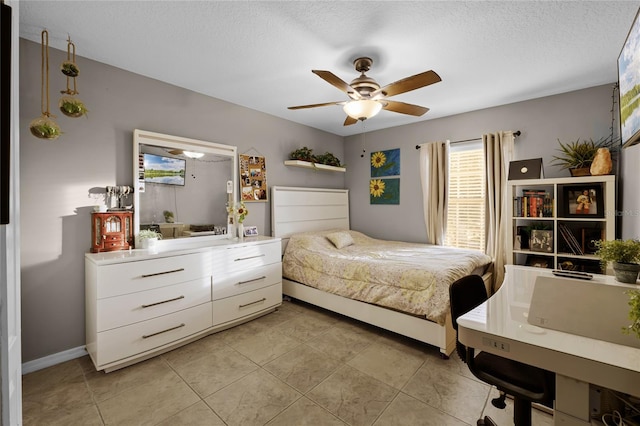 bedroom with ceiling fan, a textured ceiling, and light tile patterned floors