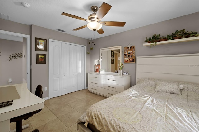 tiled bedroom featuring ceiling fan and a closet