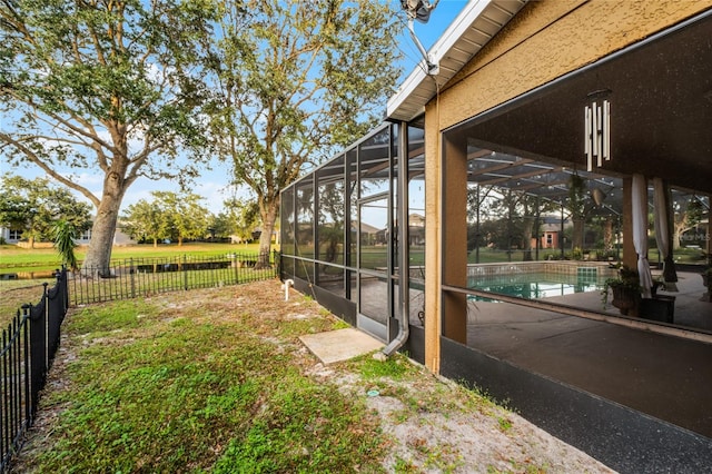 view of yard with a lanai and a fenced in pool