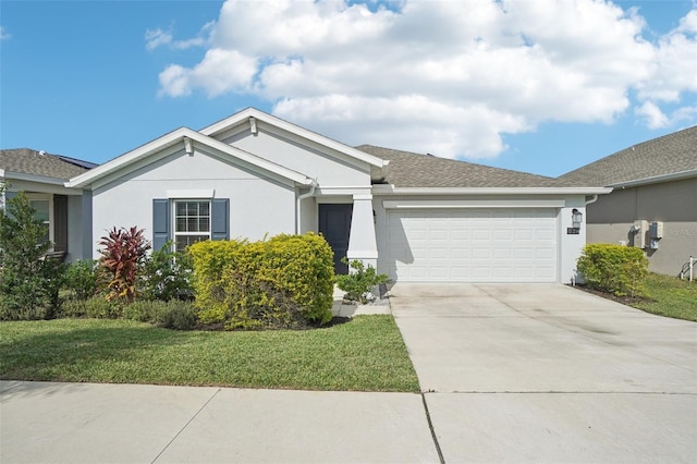 ranch-style home featuring a garage and a front lawn