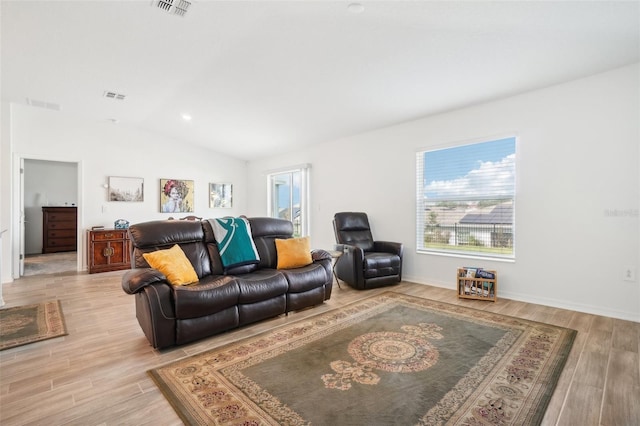 living room featuring light hardwood / wood-style flooring and vaulted ceiling