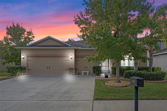 view of front of property featuring a lawn and a garage