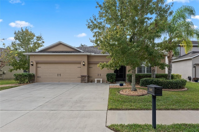 5307 Cortland Dr, Davenport, FL 33837 - view of front of house featuring a garage, stucco siding, concrete driveway, and a front yard