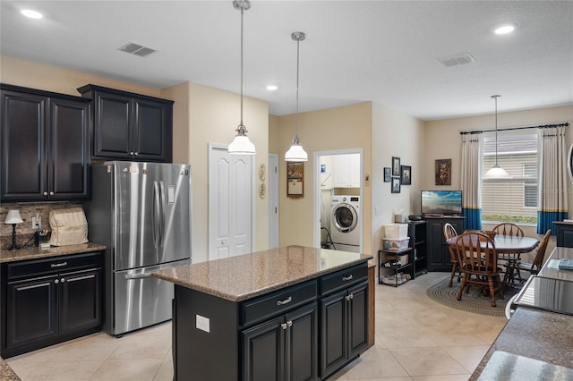 5307 Cortland Dr, Davenport, FL 33837 - kitchen featuring freestanding refrigerator, washer / clothes dryer, recessed lighting, hanging light fixtures, and light tile patterned floors