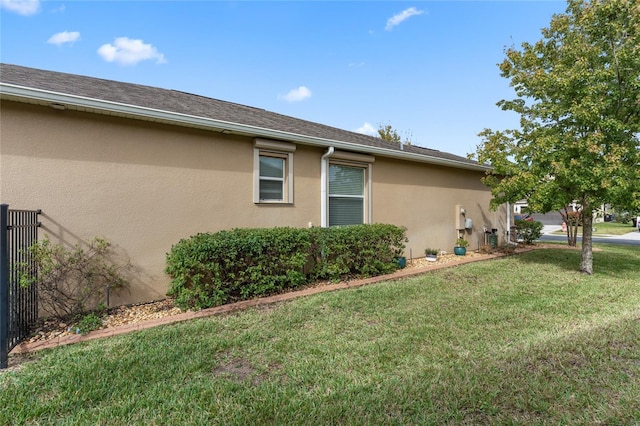 5307 Cortland Dr, Davenport, FL 33837 - view of side of property featuring stucco siding and a yard