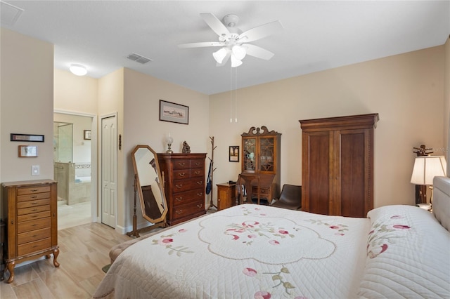 5307 Cortland Dr, Davenport, FL 33837 - bedroom featuring ensuite bathroom, light wood-style flooring, and a ceiling fan