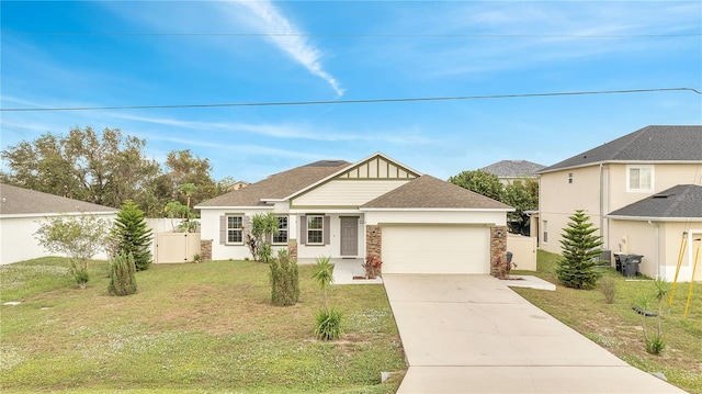 view of front of property with a front yard and a garage