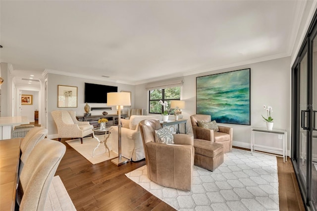 living room with light hardwood / wood-style floors and crown molding