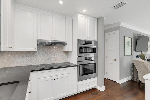 kitchen featuring ornamental molding, stainless steel double oven, black electric cooktop, dark hardwood / wood-style floors, and white cabinetry