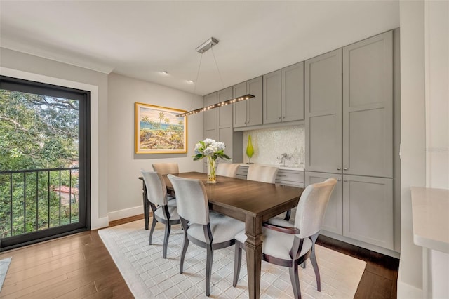 dining space with dark hardwood / wood-style flooring