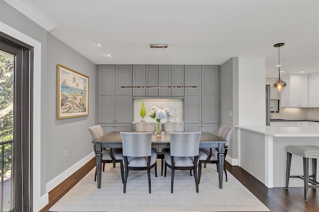 dining room with sink and hardwood / wood-style flooring