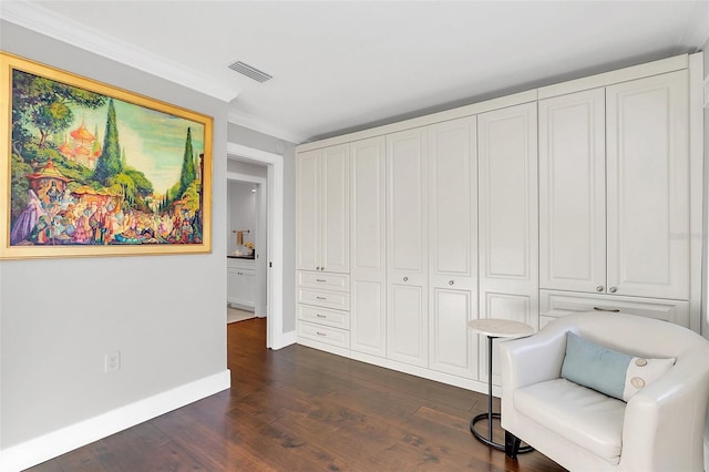 living area featuring crown molding and dark hardwood / wood-style flooring