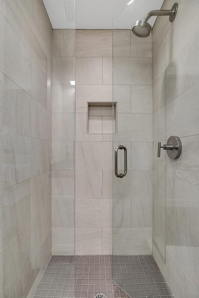 bathroom featuring a shower with door