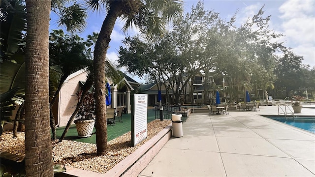 view of home's community featuring a patio and a pool