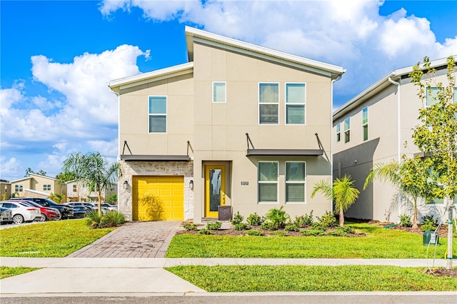 view of front of home featuring a garage and a front lawn