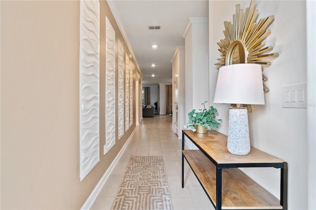 hall with crown molding and light tile patterned flooring