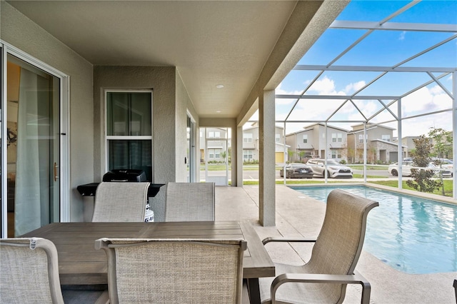 view of patio featuring a lanai