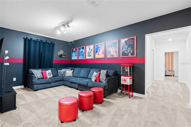 living room featuring carpet flooring, a textured ceiling, and rail lighting