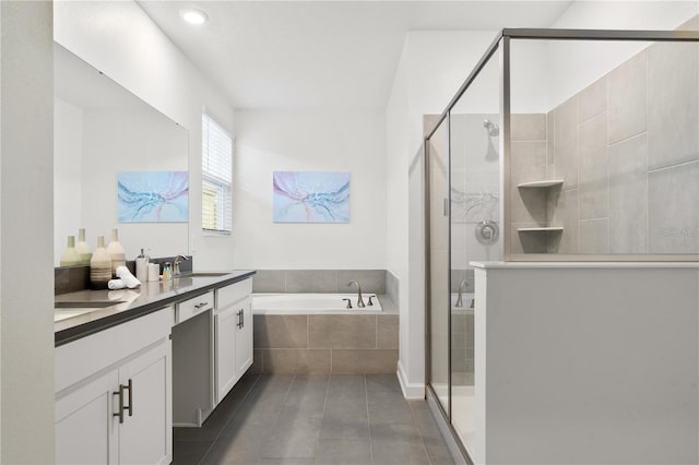 bathroom featuring tile patterned floors, vanity, and independent shower and bath