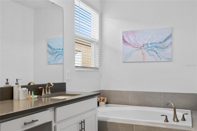 bathroom featuring vanity and a relaxing tiled tub