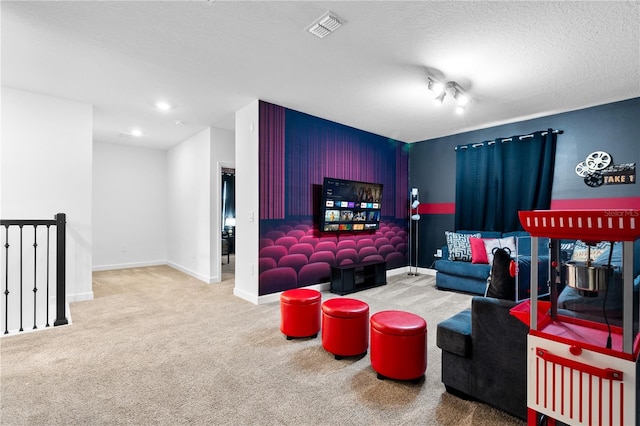 home theater room featuring carpet and a textured ceiling