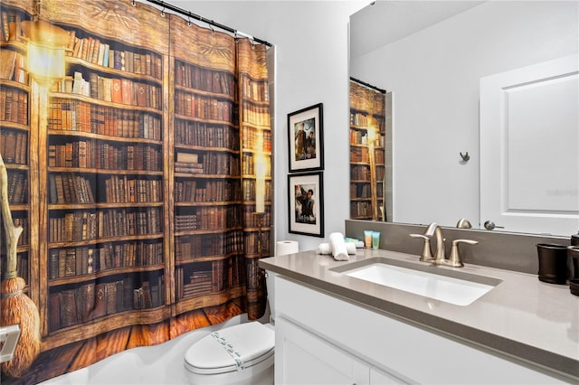 bathroom with vanity, curtained shower, and toilet