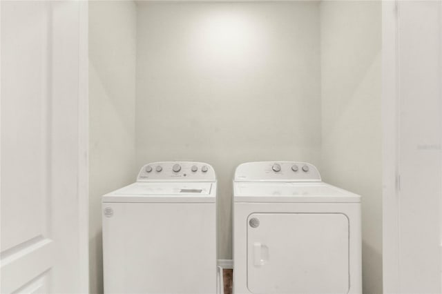 clothes washing area with separate washer and dryer