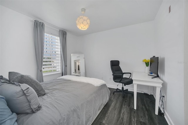 bedroom with dark wood-type flooring