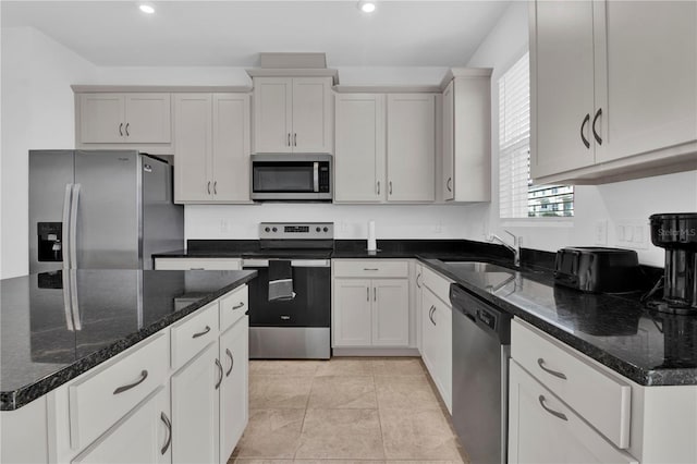 kitchen with white cabinetry, appliances with stainless steel finishes, sink, and light tile patterned floors