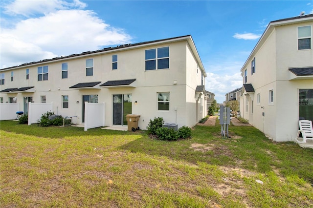 rear view of property with a lawn