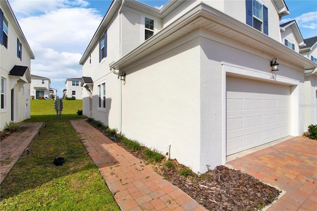 view of home's exterior featuring a garage and a yard