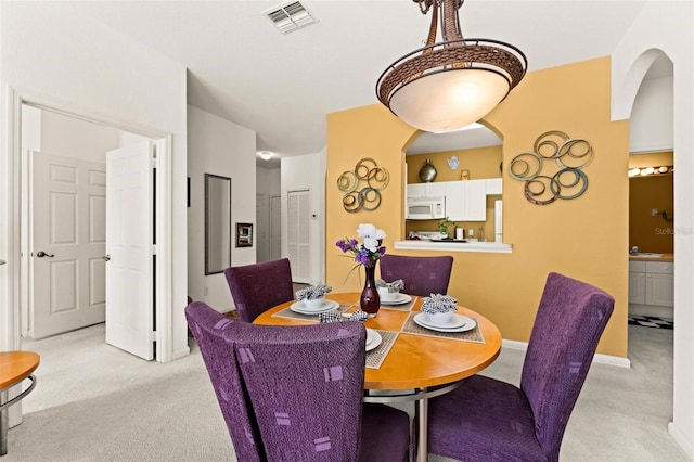 dining space featuring light colored carpet